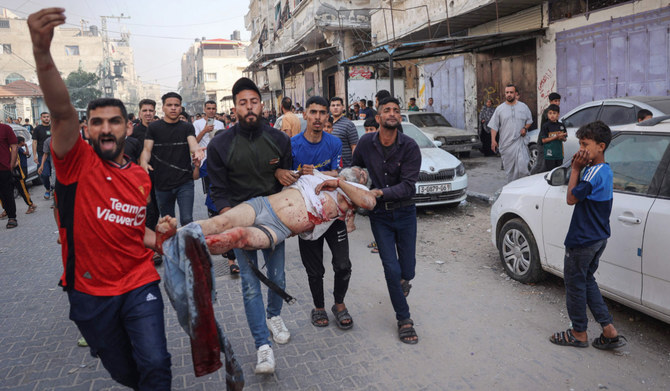 Palestinians transport an injured man pulled from the rubble of a house destroyed in an Israeli strike in the center of Rafah in the southern Gaza Strip on May 5, 2024, amid the ongoing conflict between Israel and the Palestinian Hamas movement. (AFP)