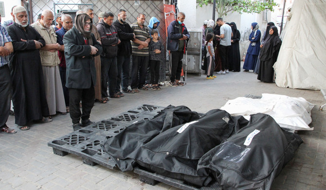 Mourners react next to the bodies of Palestinians killed in an Israeli strike, amid the ongoing conflict between Israel and the Palestinians, at Abu Yousef al-Najjar hospital in Rafah, in the southern Gaza Strip, May 5, 2024. (REUTERS)