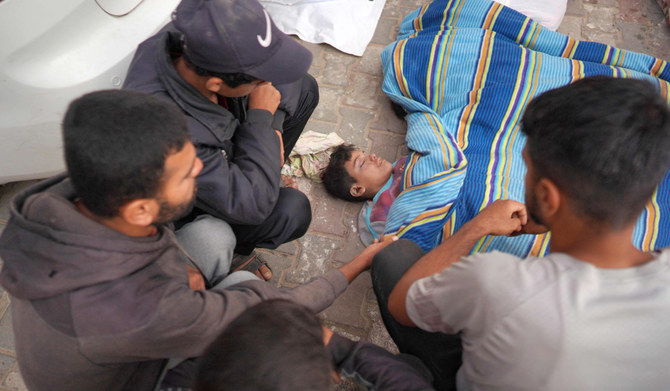 Palestinians surround the body of a young boy killed in Israeli bombardment, in the yard of the Al-Aqsa Martyrs Hospital in Deir al-Balah in the central Gaza Strip on May 11, 2024, amid the ongoing conflict between Israel and the Palestinian Hamas movement. (AFP)