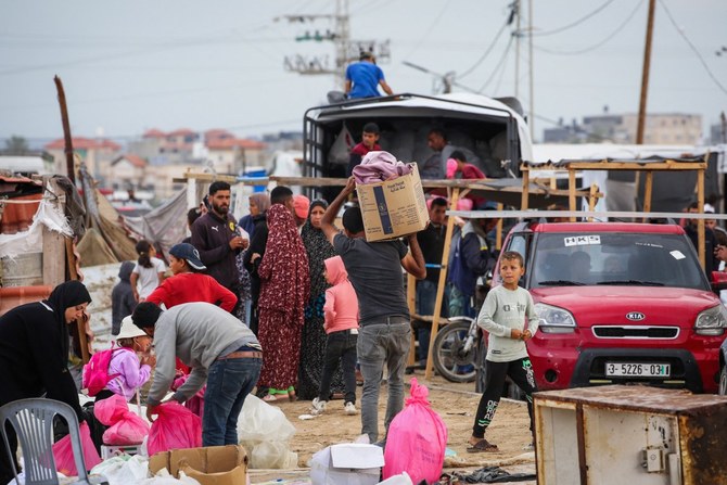 Palestinian pack their belongings as they prepare to flee Rafah in the southern Gaza Strip on May 13, 2024, amid the ongoing conflict between Israel and the Hamas militant group (AFP)