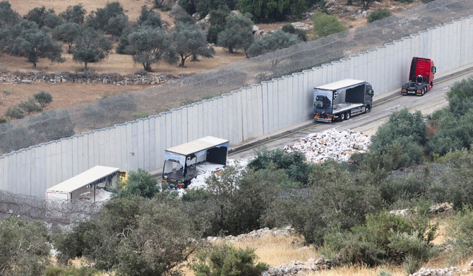 A view of trucks carrying aid to Gaza that were stopped after they were damaged by Israeli settlers near a checkpoint near Hebron in the Israeli-occupied West Bank May 14,2024. (REUTERS)
