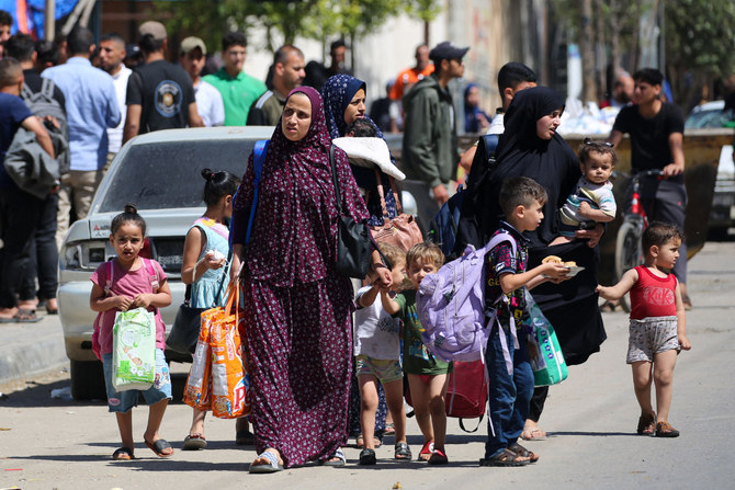 Palestinian women and children flee Rafah in the southern Gaza Strip with some belongings on May 15, 2024, amid the ongoing conflict between Israel and the militant movement Hamas. (AFP)