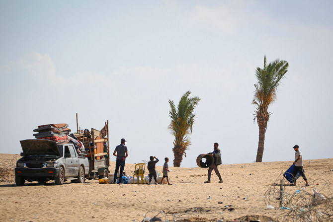 Displaced Palestinians pack their belongings after dismantling their tents before leaving an unsafe area in Rafah on May 15, 2024, as Israeli forces continued to battle and bomb Hamas militants around the southern Gaza Strip city. (AFP)