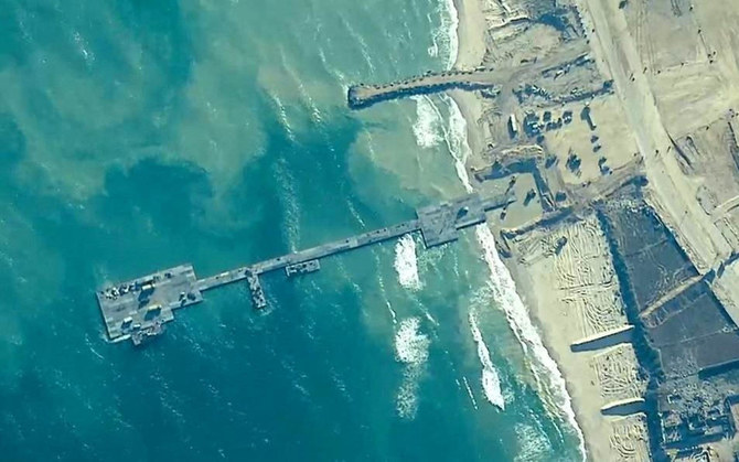 Members of the US Army, US Navy and the Israeli military put in place the Trident Pier, a temporary pier to deliver humanitarian aid, on the Gaza coast. (REUTERS)