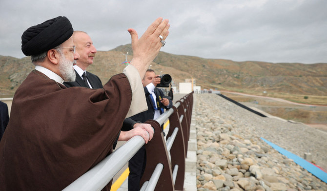Iranian President Ebrahim Raisi and Azerbaijan's President Ilham Aliyev visit the Qiz-Qalasi dam on the Azerbaijan-Iran border, May 19, 2024. (REUTERS)