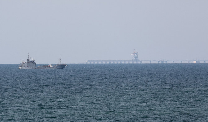 A ship loaded with aid sails near a US-built pier on May 18, 2024. (Reuters)