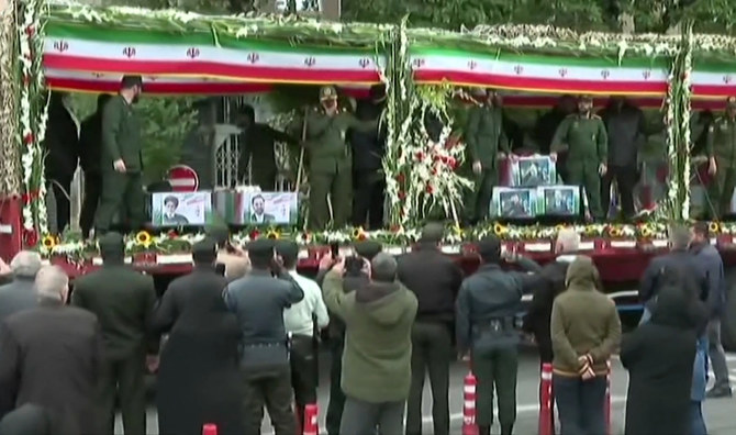 Above, the coffins of Iranian president Ebrahim Raisi and seven members of his entourage are loaded on a truck during a funerary procession in the northwestern city of Tabriz in this grab from a handout video footage. (Iran Press/AFP)