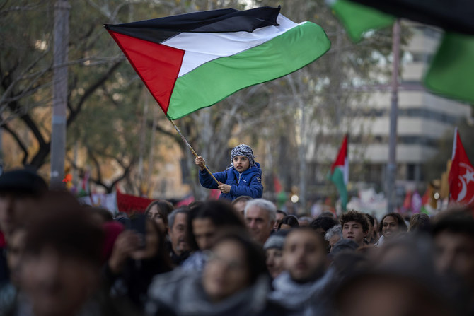 Above, a boy waves a Palestinian flag as demonstrators march during a protest in Barcelona on Jan. 20, 2024. Spain would recognize an independent Palestinian state on Tuesday May 28. (AP)