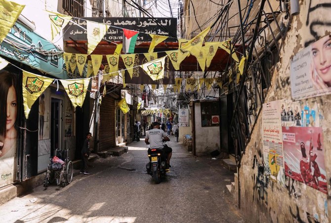 A man drives a motorbike in an alley in the Palestinian refugee camp of Shatila in Beirut's southern suburb on May 22, 2024. (AFP)