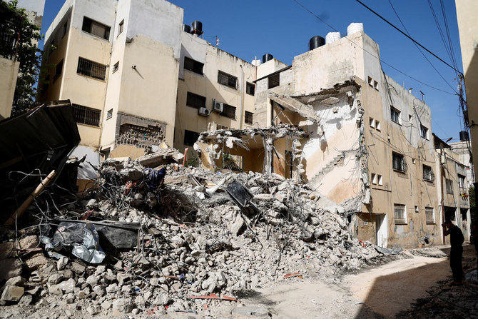 A Palestinian man inspects the damage, in the aftermath of an Israeli raid on Jenin camp in the Israeli-occupied West Bank, May 23, 2024. REUTERS /Raneen Sawafta