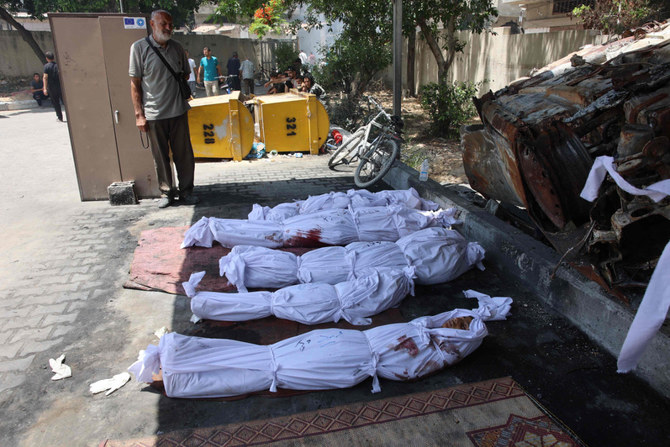 A Palestinian mourns over bodies of Gazans killed in an Israeli strike ahead of their funeral at a clinic in Gaza City on May 25, 2024. (AFP)