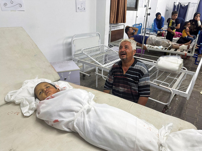 A man reacts next to the body of a Palestinian child killed in an Israeli strike on an area designated for displaced people in Rafah on May 26, 2024. (REUTERS)
