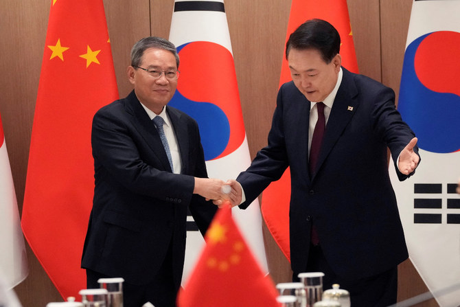 South Korean President Yoon Suk Yeol, right, greets Chinese Premier Li Qiang during a meeting at the Presidential Office in Seoul on May 26, 2024. (Pool via REUTERS)