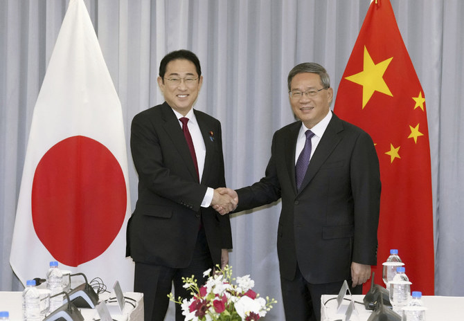 Japanese Prime Minister KISHIDA Fumio, left, shakes hands with Chinese Premier Li Qiang before their meeting in Seoul, South Korea, on May 26, 2024. (Kyodo News via AP)