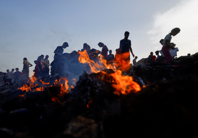 Israeli airstrikes killed at least 40 people Sunday and hit tents for displaced people in the southern Gaza city of Rafah. Above, Palestinians search for food among burnt debris from the strike on May 27, 2024. (Reuters)