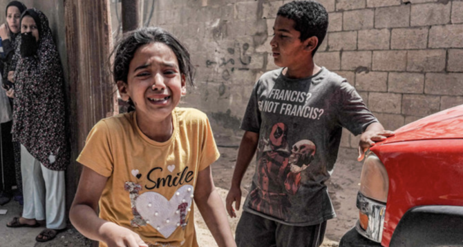 Children react as they flee following Israeli bombardment in Nuseirat in the central Gaza Strip on April 29, 2024, amid the ongoing conflict in the Palestinian territory between Israel and the militant group Hamas. (AFP)