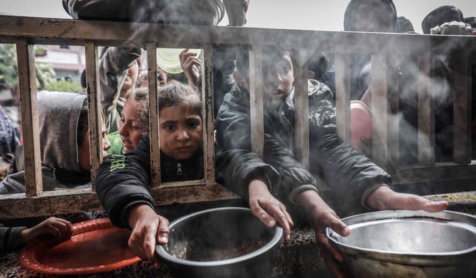 Displaced Palestinian children gather to receive food at a government school in Rafah in the southern Gaza Strip on February 19, 2024, amid the ongoing battles between Israel and the militant group Hamas. (AFP file photo)