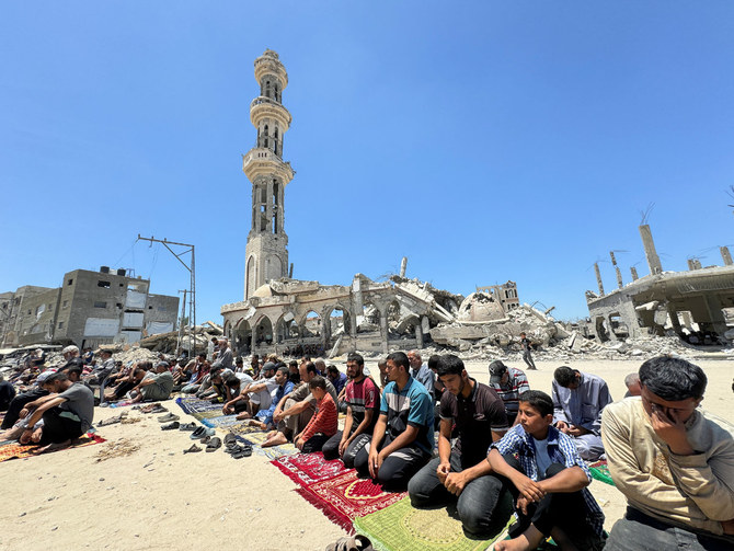 Palestinians perform Friday prayers at the ruins of a mosque destroyed in the Israeli military offensive in Khan Younis, southern Gaza Strip, on May 31, 2024. (REUTERS)