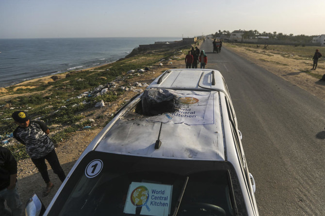 Palestinians inspect a vehicle with the logo of the World Central Kitchen wrecked by an Israeli airstrike in Deir al Balah, Gaza Strip, April 2, 2024. (AP)