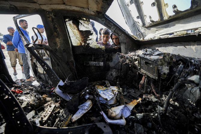 People inspect the site where World Central Kitchen workers were killed in Deir al-Balah, Gaza Strip, April 2, 2024. (AP)