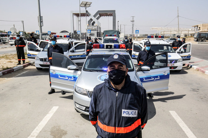 In this photo taken on May 12, 2020, Hamas security officers regulate entry at the Rafah border crossing with Egypt in the southern Gaza Strip amid the COVID-19 coronavirus pandemic. Israel seeks replace the deeply entrenched Hamas with an alternative local governing body for Gaza. (AFP)