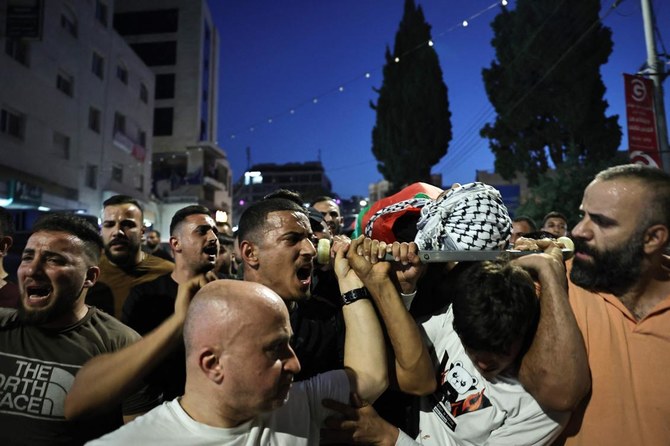 Mourners carry the body of a Palestinian resident hours after he was killed during an Israeli raid on the Balata refugee camp, east of the Israeli occupied West Bank city of Nablus on June 3, 2024. (AFP)