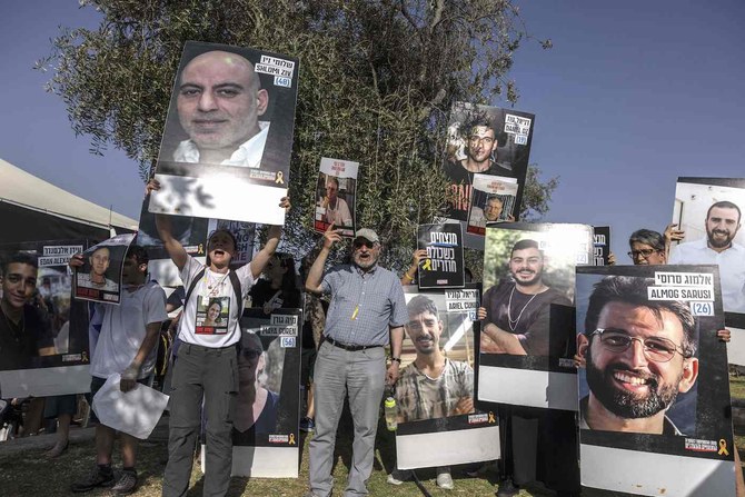 Relatives and friends of Israelis held hostage by Hamas in the Gaza Strip, gather to listen to the Israeli Finance Minister during a rally in the center of Jerusalem on June 3, 2024. (AFP)