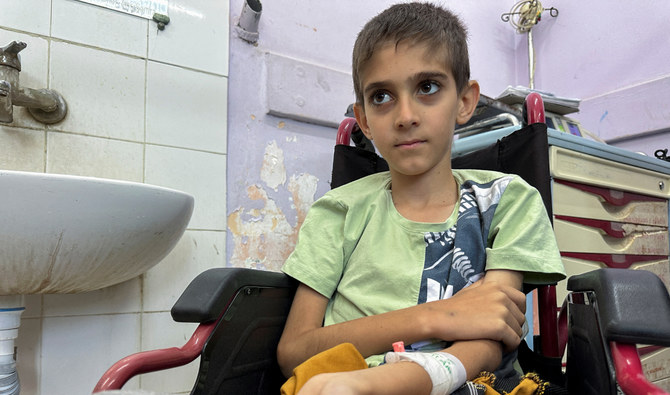 Siraj Yassin, a Palestinian boy with cancer, looks on as he receives treatment at Al-Aqsa hospital in central Gaza Strip on June 1, 2024. (Reuters).