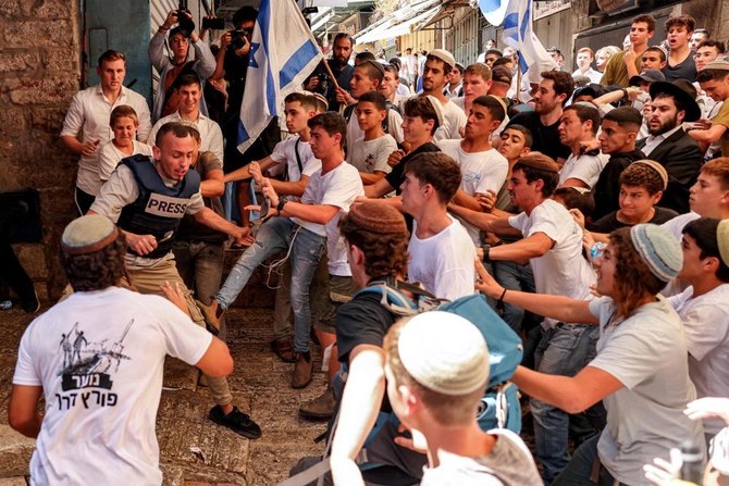 An Israeli mob attacks journalist Saif Kwasmi on Wednesday in Jerusalem. (AFP)