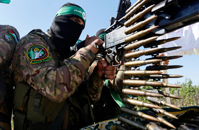 File photo of a Palestinian fighter from the armed wing of Hamas takes part in a military parade to mark the anniversary of the 2014 war with Israel, near the border in the central Gaza Strip. (REUTERS)
