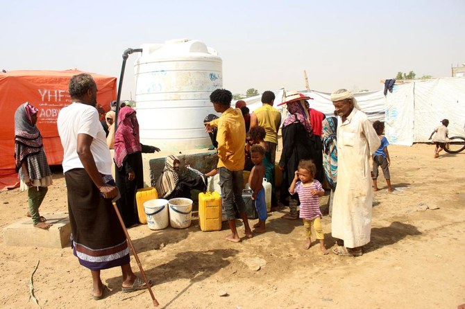 Internally displaced Yemenis queue to collect portable water at a camp in the Abs District of Hajjah Governorate as the humanitarian crisis continues in Yemen following the start of the civil war in 2014. (File/AFP)