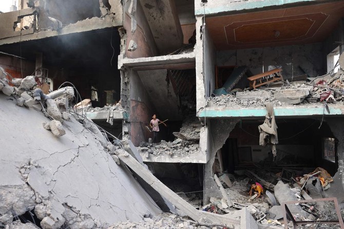 Palestinians children search through the rubble of their home a day after an operation by the Israeli military at the Nuseirat camp in the central Gaza Strip on June 9, 2024. (AFP)