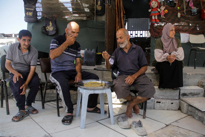Palestinian sit at a makeshift home, amid the ongoing conflict between Israel and Hamas, in Beit Lahia in the northern Gaza Strip, on June 12, 2024. (REUTERS)