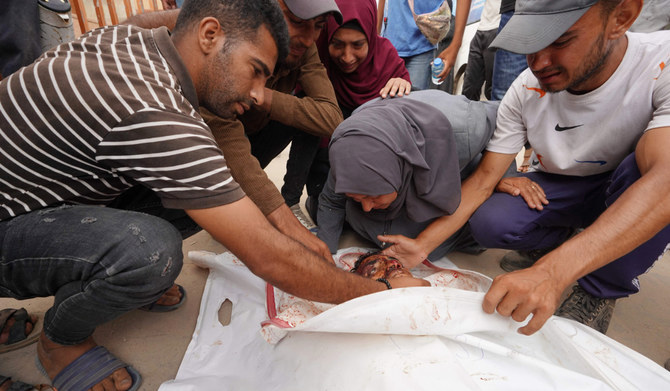 A Palestinian woman grieves as she bids farewell to a relative, killed the day before in a strike on the al-Mawasi area, northwest of the Palestinian city of Rafah on June 22, 2024, amid the ongoing conflict between Israel and the Palestinian Hamas militant group. (AFP)