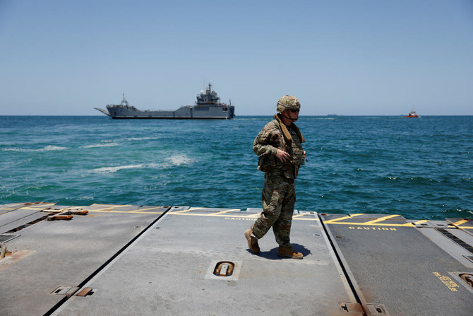 A soldier stands at Trident Pier, a temporary pier to deliver aid off the Gaza Strip, near the Gaza coast, on June 25, 2024. (Reuters)