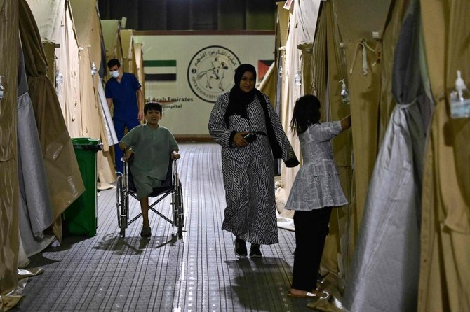 A young Palestinian amputee evacuated from the Gaza Strip sits on a wheelchair inside an Emirati floating hospital in the Egyptian port of Al-Arish on Jul. 4, 2024. (AFP)