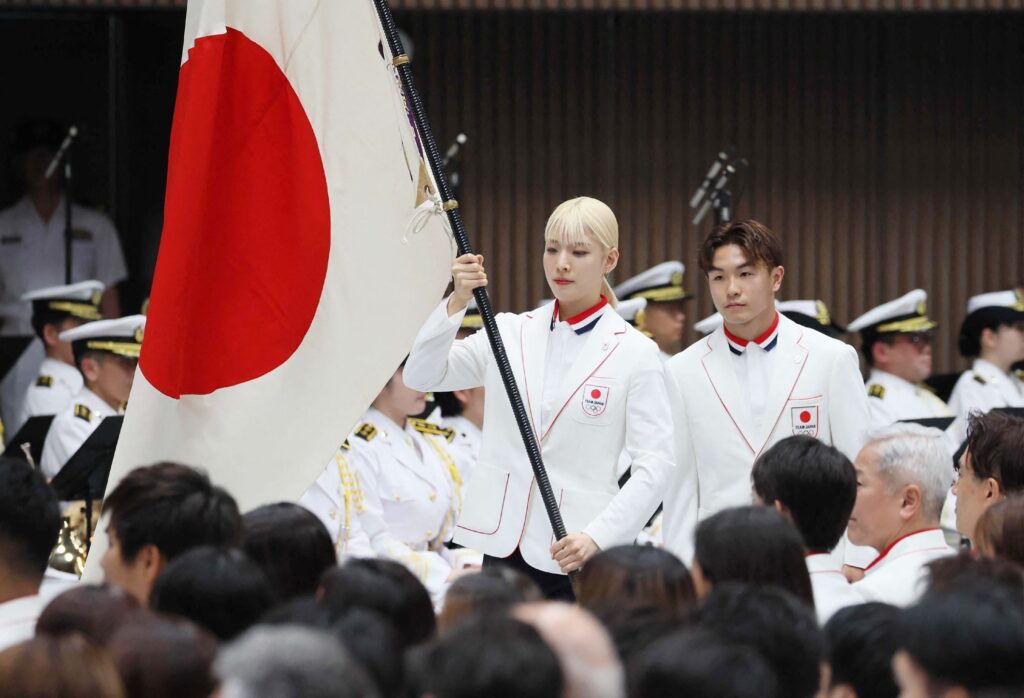 Flagbearers for the opening ceremony of the 2024 Paris Olympic Games, world sabre fencing champion Misaki Emura (centre L) and breakdancer Shigeyuki