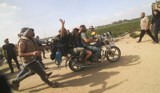 Palestinians transport a captured Israeli civilian, Noa Argamani, on a motorcycle from southern Israel, in the Gaza Strip on Oct. 7, 2023. (AP)