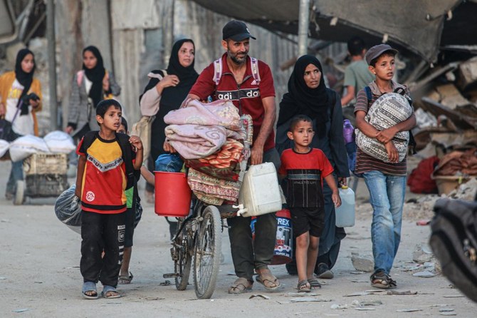 Displaced Palestinians leave as area in east Khan Yunis after the Israeli army issued a new evacuation order for parts of Khan Yunis and Rafah, in the southern Gaza Strip on July 1, 2024, amid the ongoing conflict between Israel and the Palestinian Hamas militant group. (AFP)