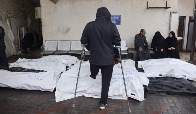 Palestinians mourn by bodies of relatives killed following overnight Israeli strikes on Rafah in the southern Gaza Strip on May 6, 2024, amid the ongoing conflict between Israel and the Palestinian Hamas movement. (AFP)