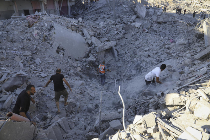 Palestinians search for bodies and survivors in the rubble of a residential building destroyed in an Israeli airstrike in Khan Younis on Jul. 3, 2024. (AP)
