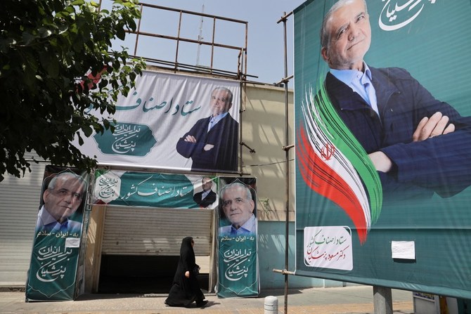 A banner featuring presidential candidate Masoud Pezeshkian is displayed on a street in Tehran. (WANA/Reuters)