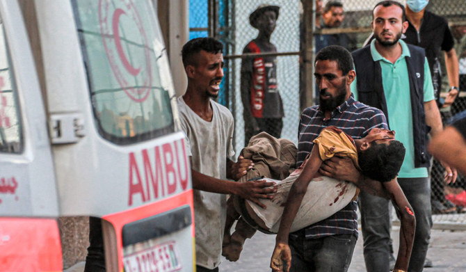 The body of a victim killed by Israeli bombardment is carried to an ambulance at the Nasser Medical Complex in Khan Yunis in the southern Gaza Strip on July 5, 2024 amid the ongoing conflict in the Palestinian territory between Israel and Hamas. (AFP)