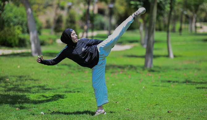 Palestinian Karate-ka, 18-year-old Mais Elbostami, trains in a park near her home, east of the Egyptian capital Cairo on June 25, 2024. (AFP)