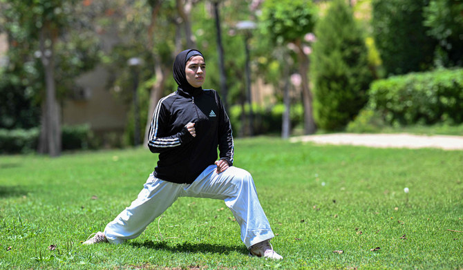 Palestinian Karate-ka, 18-year-old Mais Elbostami, trains in a park near her home, east of the Egyptian capital Cairo on June 25, 2024. (AFP)