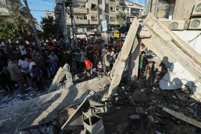 Palestinians gather at the site of an Israeli air strike on a UN school sheltering displaced people, amid the Israel-Hamas conflict, in Nusairat in central Gaza Strip, July 6, 2024. (Reuters)