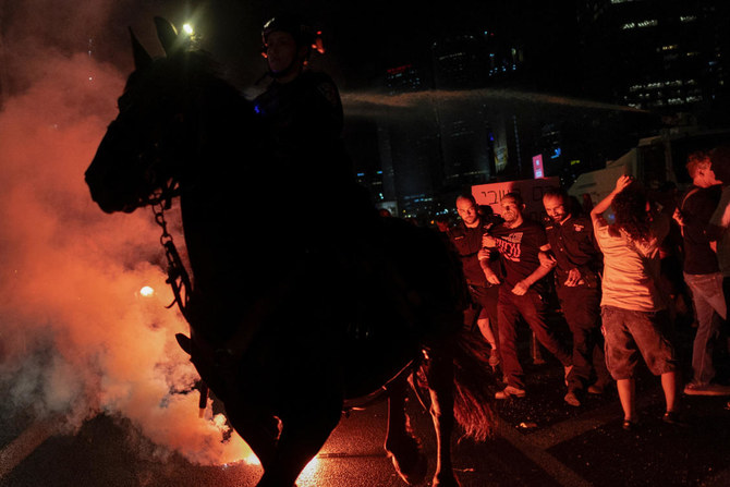 Police escort a protester next to mounted police during a demonstration against Israeli Prime Minister Benjamin Netanyahu's government and a call for the release of hostages in Gaza, amid the Israel-Hamas conflict, in Tel Aviv, Israel. (Reuters)