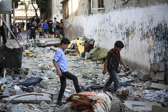 Palestinians asses the damage following an Israeli strike in the Nuseirat refugee camp in the central Gaza Strip on July 6. (File/AFP)