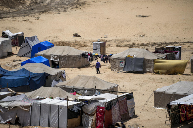 Dozens of Palestinians were killed and injured on Tuesday by an Israeli airstrike that hit tents housing displaced families outside a school in Abassan in the southern Gaza Strip. (AP/File)