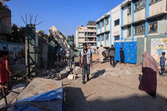 A UN staff checks the destruction at a UN-run school sheltering displaced people after Israeli bombardment in Nuseirat in the central Gaza Strip on July 9, 2024. Israeli forces launched more deadly strikes across Gaza on Wednesday, according to medical sources and the military. (AFP)